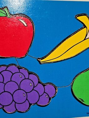 Colorful Fruit Puzzle Board.Blue Background, Red, Yellow, Purple, Green Pieces